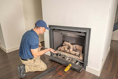 Technician working on a gas fireplace